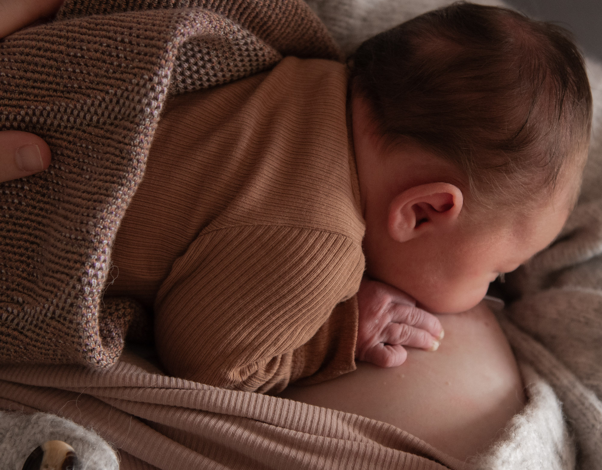 Newborn baby photographed in soft natural light